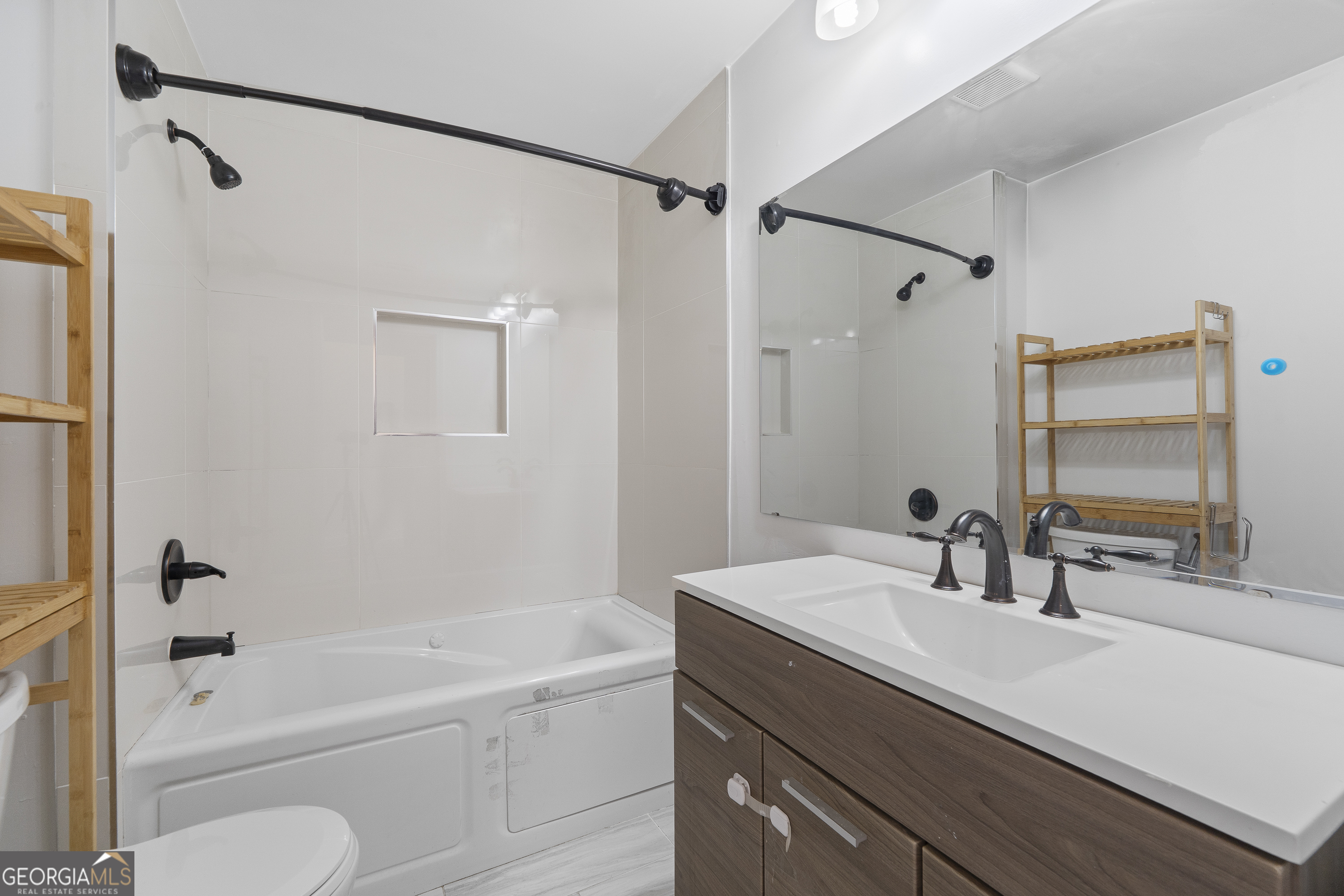 1471 Jackson Street Macon, GA 31201 - Photo 23 of 30 a bathroom with a granite countertop sink a toilet and shower