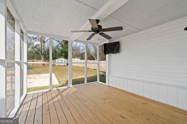 a view of a yard with wooden fence