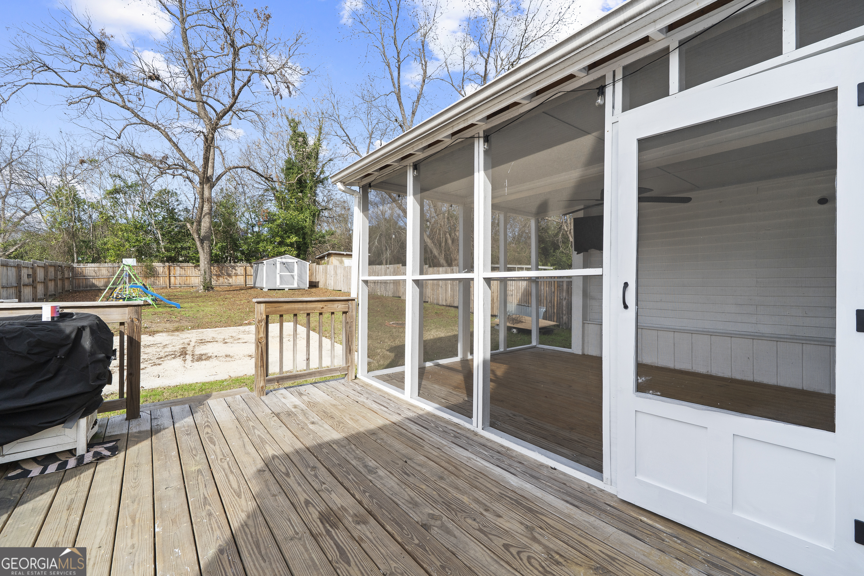 1471 Jackson Street Macon, GA 31201 - Photo 26 of 30 a view of a balcony with chairs and wooden floor