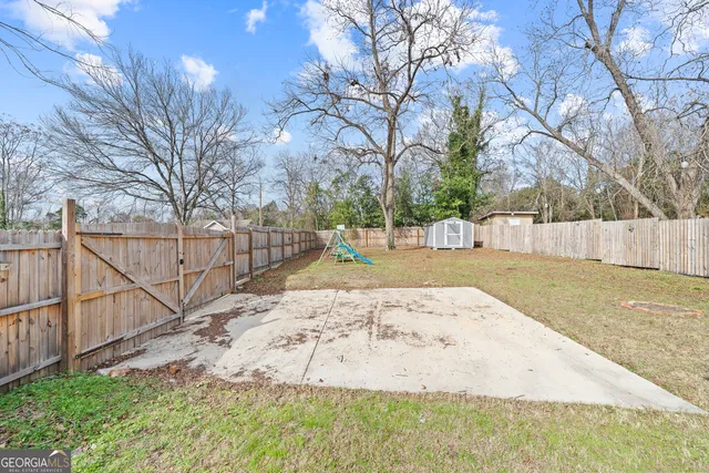 a view of a house with backyard and sitting area