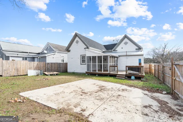 a view of a house with backyard and sitting area