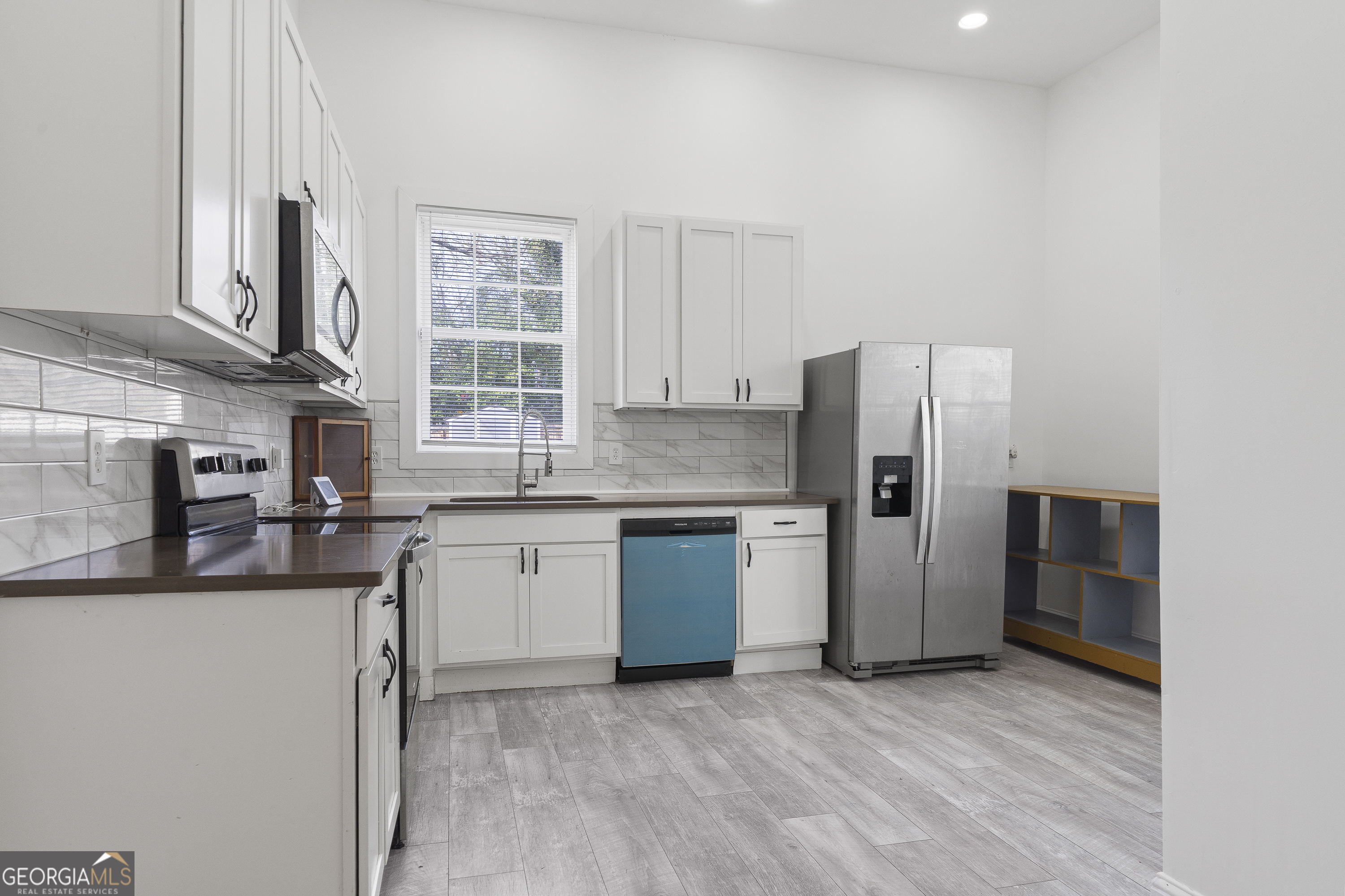 1471 Jackson Street Macon, GA 31201 - Photo 10 of 30 a kitchen with stainless steel appliances granite countertop a refrigerator and a sink