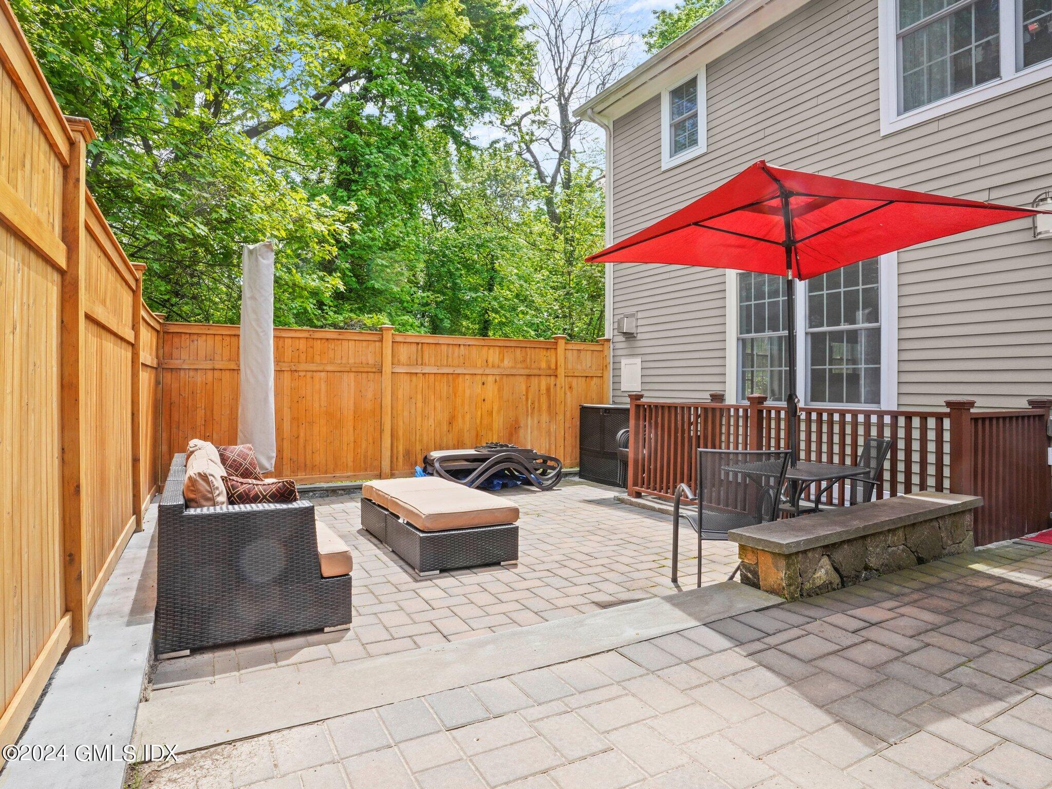 32 Cliff Avenue, Unit 3 Greenwich, CT 06830 - Photo 19 of 23 a backyard of a house with barbeque oven table and chairs