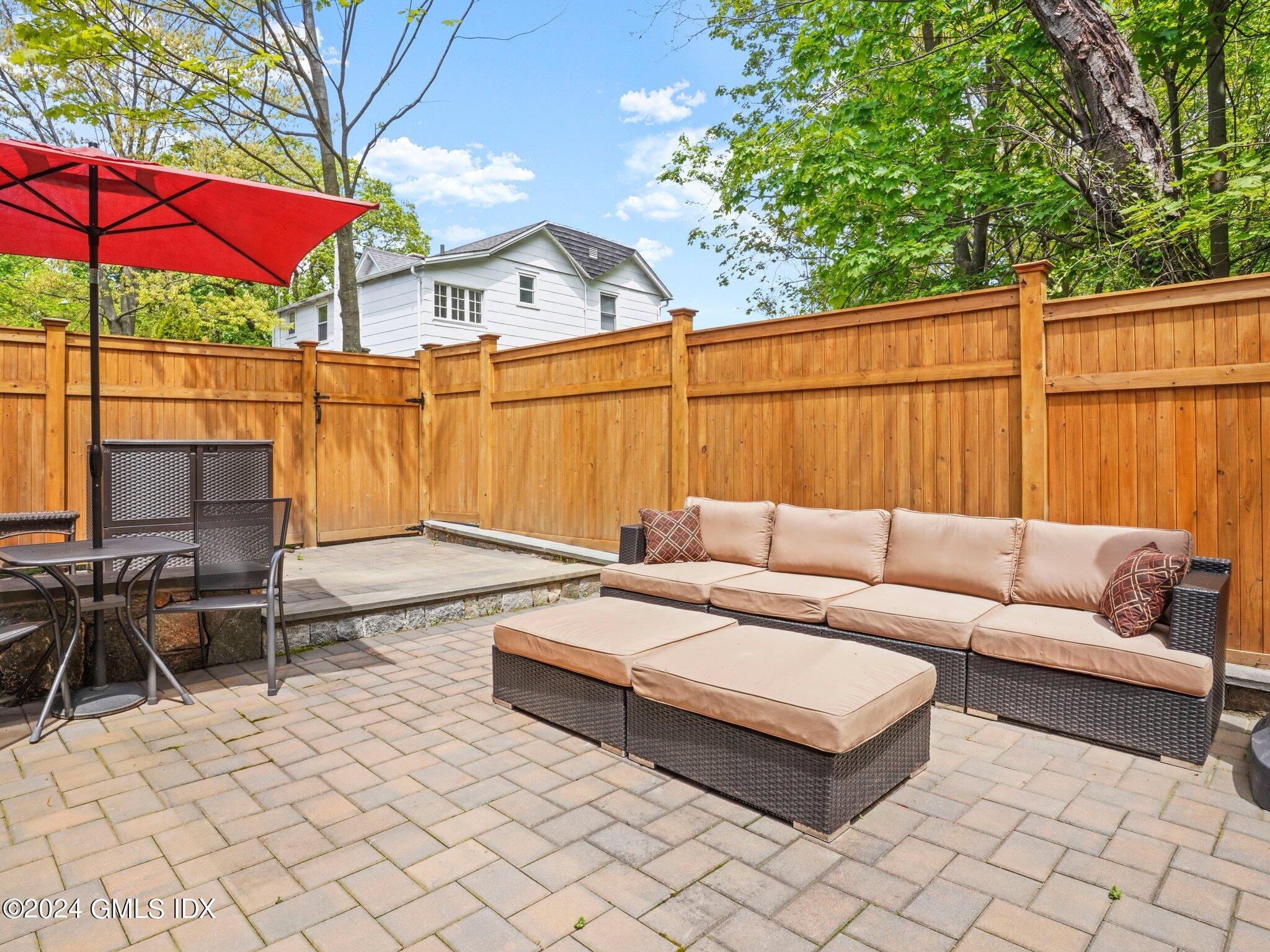 32 Cliff Avenue, Unit 3 Greenwich, CT 06830 - Photo 20 of 23 a backyard of a house with sofas fire pit and outdoor seating