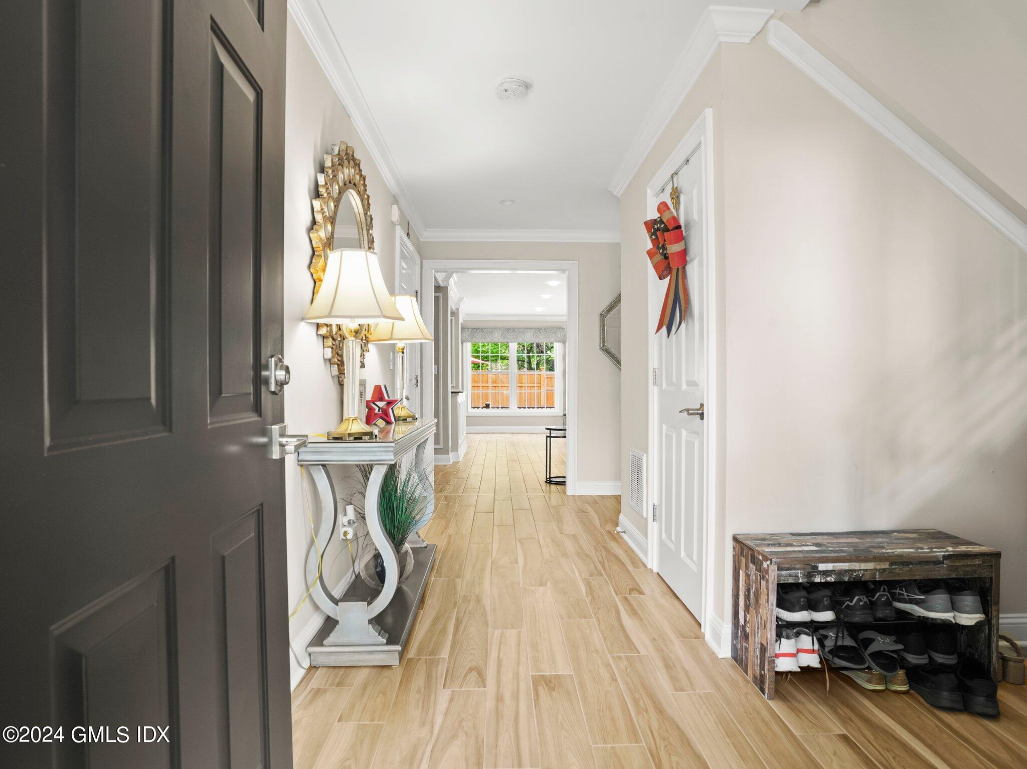 32 Cliff Avenue, Unit 3 Greenwich, CT 06830 - Photo 3 of 23 a view of a hallway with wooden floor and furniture