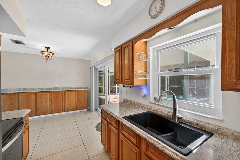 1417 Spring Lane Clearwater, FL 33755 - Photo 11 of 28 a kitchen with granite countertop a sink and a stove top oven