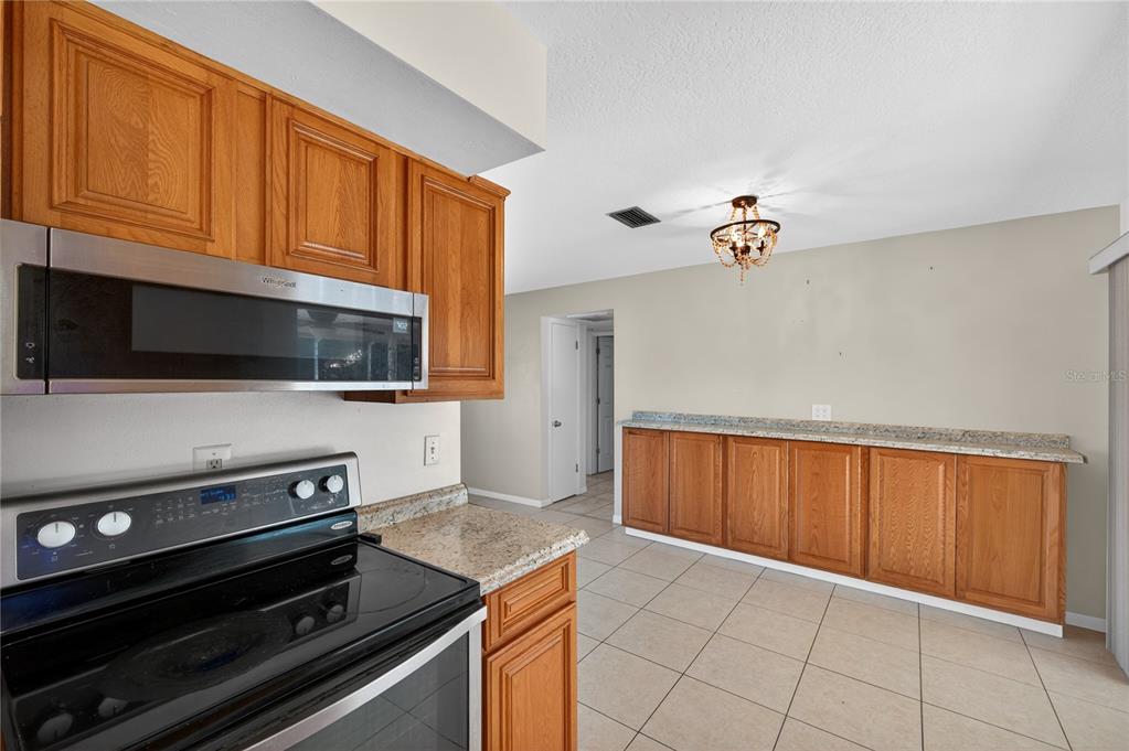 1417 Spring Lane Clearwater, FL 33755 - Photo 13 of 29 a view of kitchen and microwave