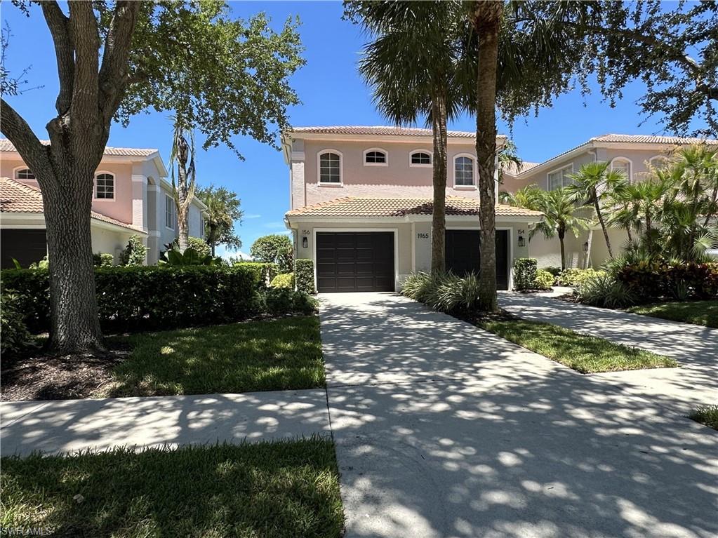 1965 Crestview Way, Unit 156 Naples, FL 34119 - Photo 1 of 45 a front view of a house with a yard and garage