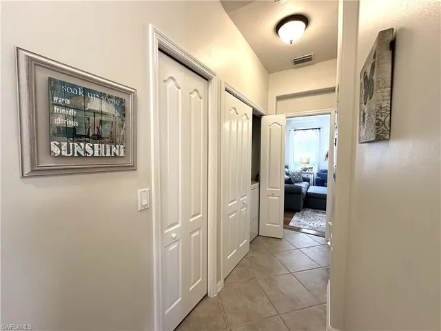 a living room with furniture a large window and a flat screen tv