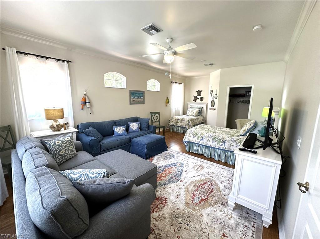 1965 Crestview Way, Unit 156 Naples, FL 34119 - Photo 13 of 45 a living room with furniture a large window and a flat screen tv