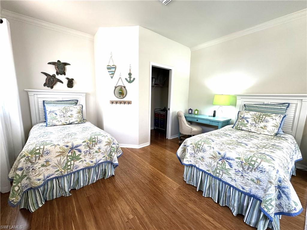 1965 Crestview Way, Unit 156 Naples, FL 34119 - Photo 14 of 45 a bedroom with bed and wooden floor