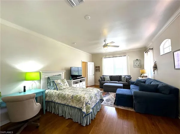a living room with furniture a large window and a chandelier