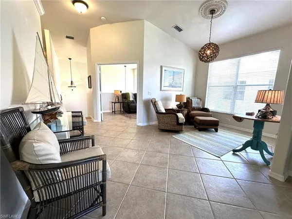 a living room with furniture and a chandelier