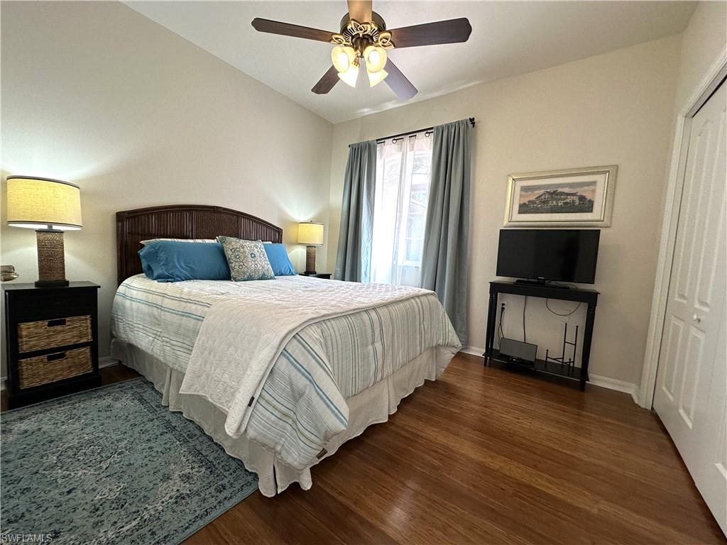 1965 Crestview Way, Unit 156 Naples, FL 34119 - Photo 20 of 45 a bedroom with a bed and wooden floor