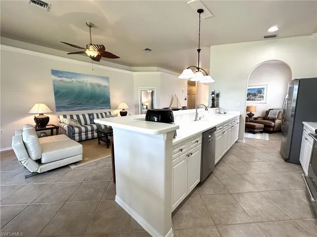 a large kitchen with a large counter top appliances and cabinets