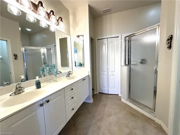 a bathroom with a sink vanity and a mirror