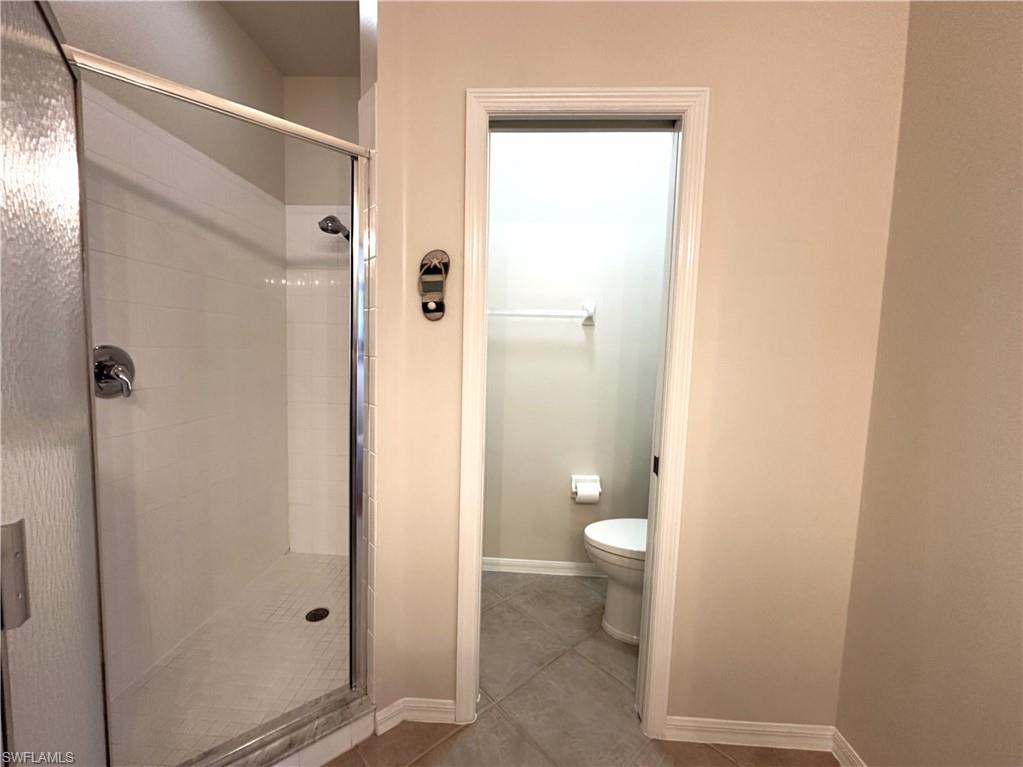 1965 Crestview Way, Unit 156 Naples, FL 34119 - Photo 31 of 45 a bathroom with a granite countertop shower and a toilet