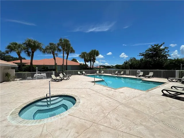 a view of a swimming pool with lounge chairs