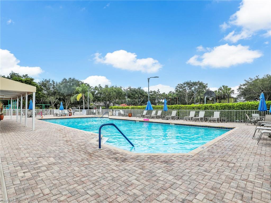 1965 Crestview Way, Unit 156 Naples, FL 34119 - Photo 39 of 45 a view of a swimming pool with a patio