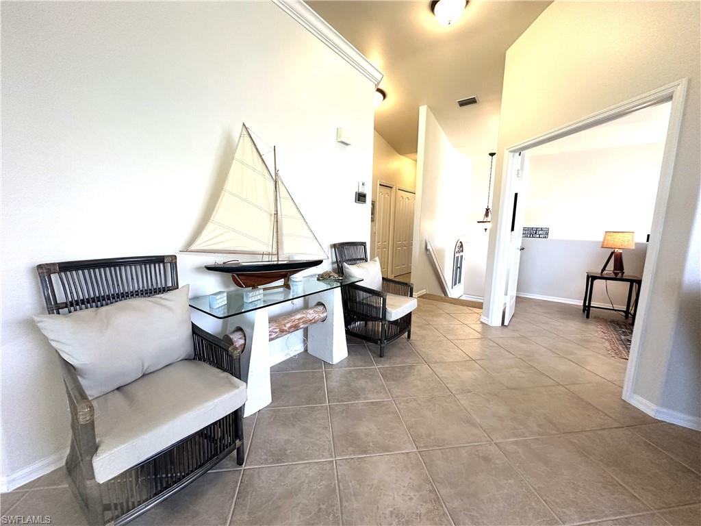 1965 Crestview Way, Unit 156 Naples, FL 34119 - Photo 7 of 45 a living room with furniture and a flat screen tv