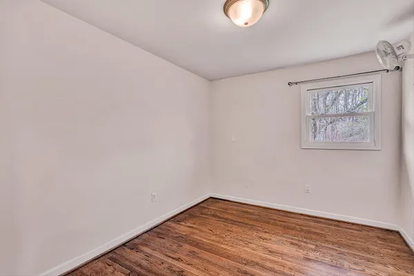 a living room with a bed furniture and a window