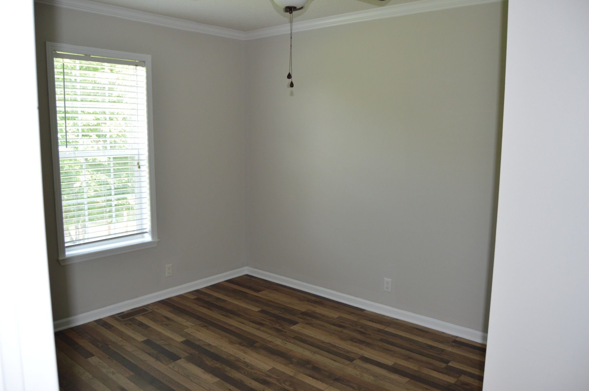 545 East Robertson Road Castalian Springs, TN 37031 - Photo 13 of 19 a view of an empty room with wooden floor and a window
