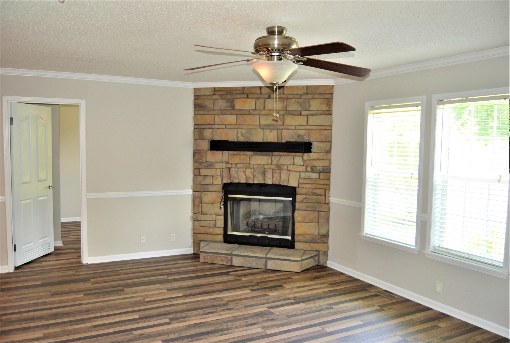 545 East Robertson Road Castalian Springs, TN 37031 - Photo 16 of 19 a view of an empty room with wooden floor fireplace and a window