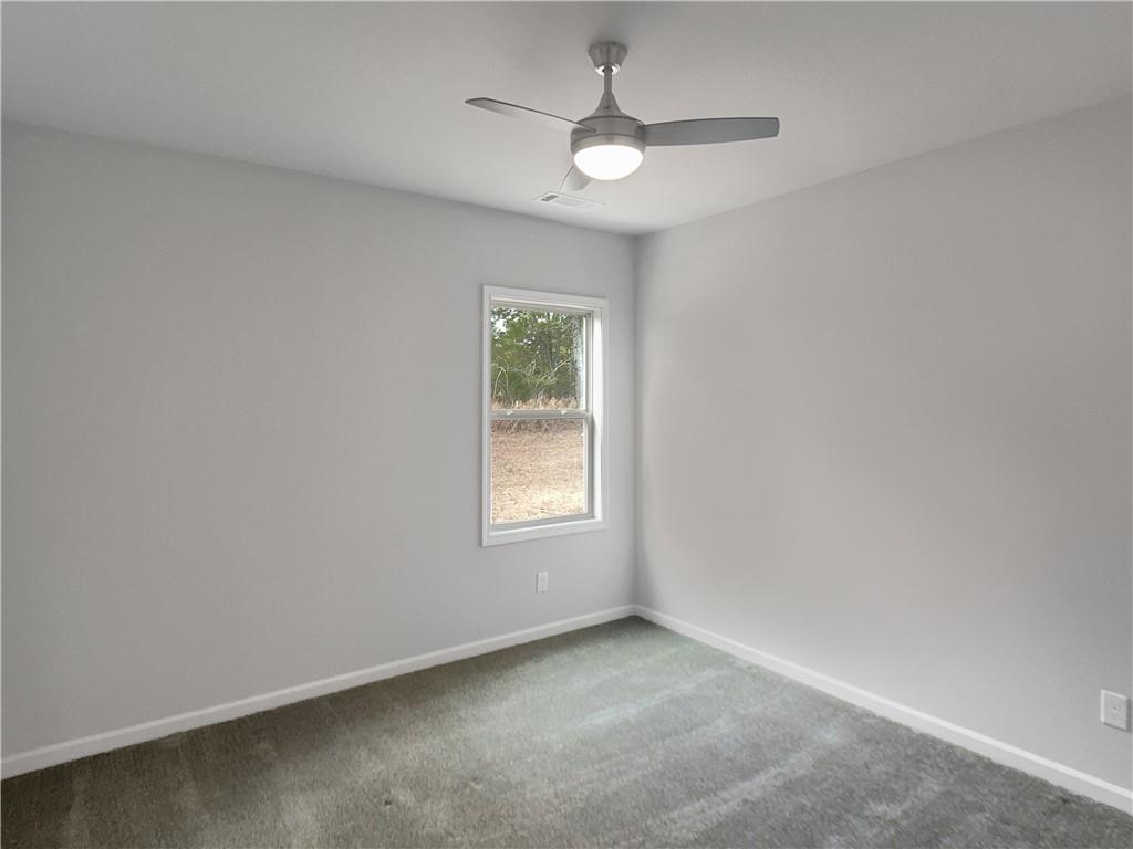 908 West Union Grove Circle Auburn, GA 30011 - Photo 12 of 16 an empty room with a window and a fan
