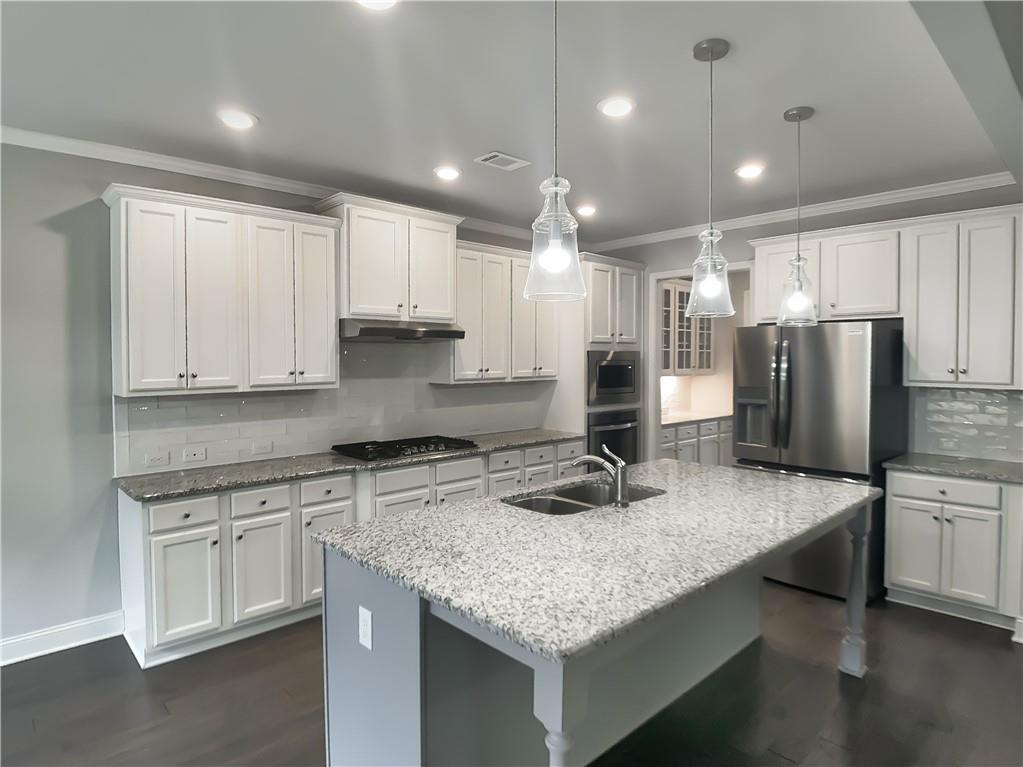 908 West Union Grove Circle Auburn, GA 30011 - Photo 2 of 16 a kitchen with stainless steel appliances granite countertop a sink refrigerator and cabinets