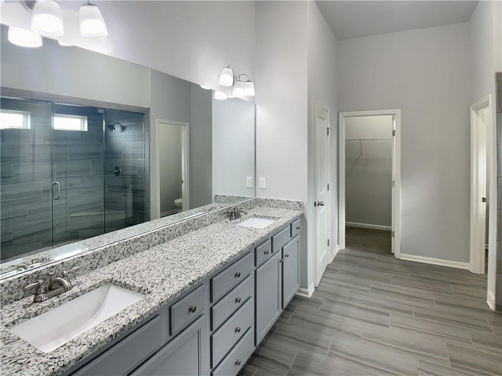 908 West Union Grove Circle Auburn, GA 30011 - Photo 6 of 16 a spacious bathroom with a granite countertop sink mirror and shower