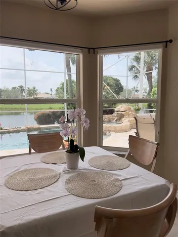 a living room with a large window and a table
