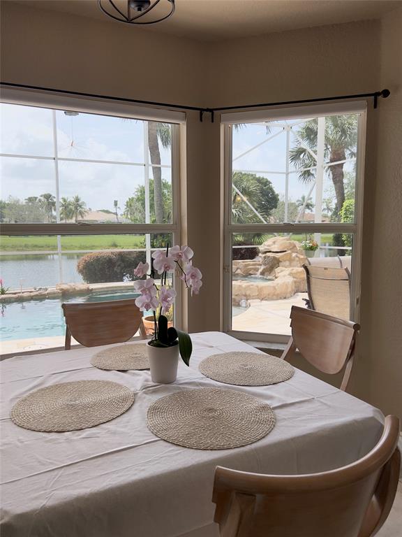 1423 Southwest 158th Avenue Pembroke Pines, FL 33027 - Photo 11 of 43 a living room with a large window and a table