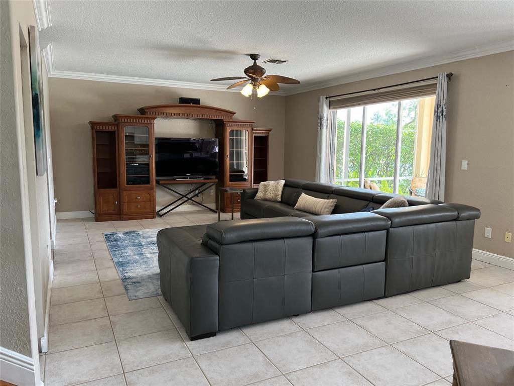 1423 Southwest 158th Avenue Pembroke Pines, FL 33027 - Photo 12 of 43 a living room with furniture and a flat screen tv