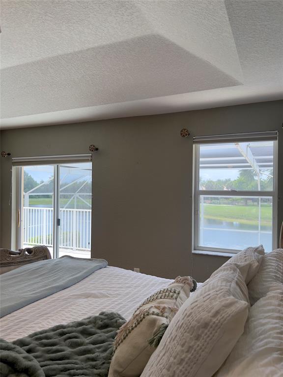 1423 Southwest 158th Avenue Pembroke Pines, FL 33027 - Photo 18 of 43 a bedroom with a bed and a large window