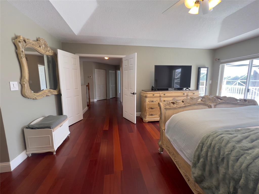 1423 Southwest 158th Avenue Pembroke Pines, FL 33027 - Photo 20 of 43 a spacious bedroom with a bed and a flat screen tv