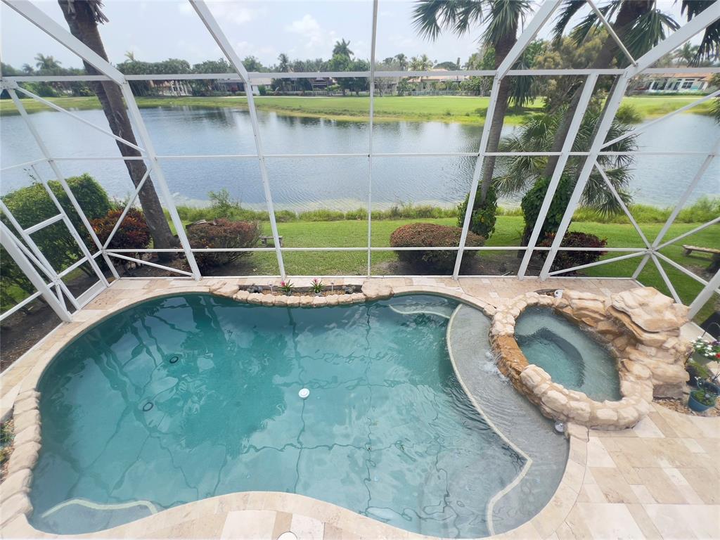 1423 Southwest 158th Avenue Pembroke Pines, FL 33027 - Photo 2 of 43 a view of a swimming pool with a yard and sitting area
