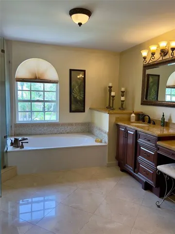 a spacious bathroom with a double vanity sink and a bathtub