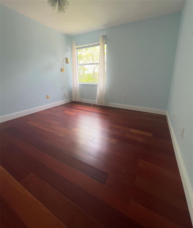 1423 Southwest 158th Avenue Pembroke Pines, FL 33027 - Photo 28 of 43 an empty room with wooden floor and windows