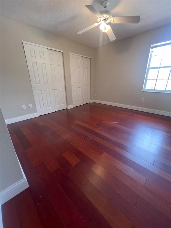 1423 Southwest 158th Avenue Pembroke Pines, FL 33027 - Photo 35 of 43 an empty room with wooden floor fan and windows