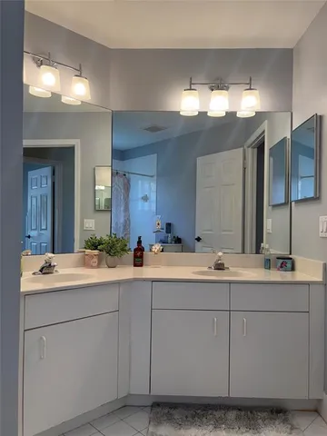 a room with a sink vanity and mirror