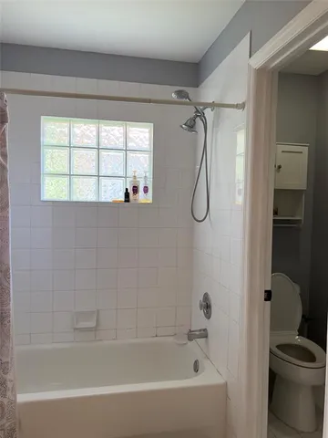 a bathroom with a bath tub with a shower
