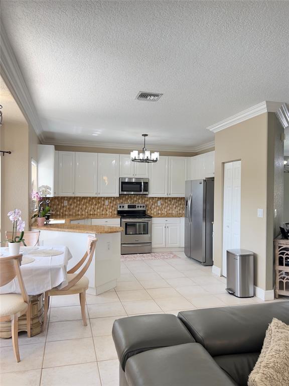 1423 Southwest 158th Avenue Pembroke Pines, FL 33027 - Photo 8 of 43 a living room with stainless steel appliances kitchen island granite countertop furniture and a kitchen view