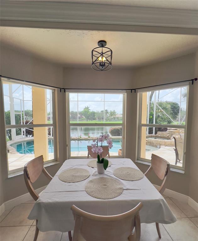 1423 Southwest 158th Avenue Pembroke Pines, FL 33027 - Photo 10 of 43 a dining room with furniture large windows and wooden floor
