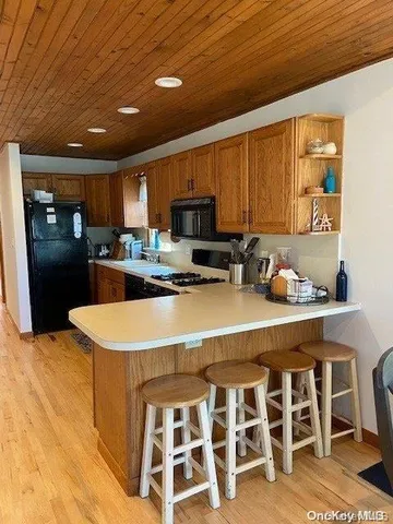 a kitchen with a dining table chairs stainless steel appliances and cabinets