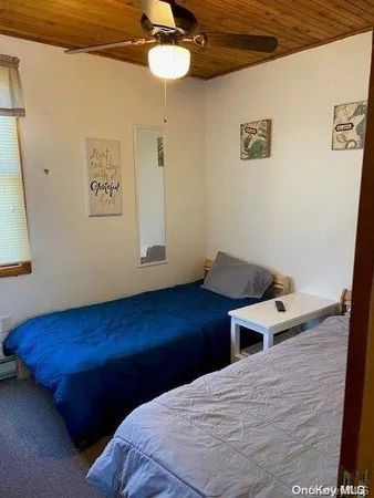 a bedroom with a bed and a night stand