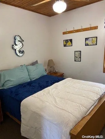 a bedroom with a bed and painting on the wall