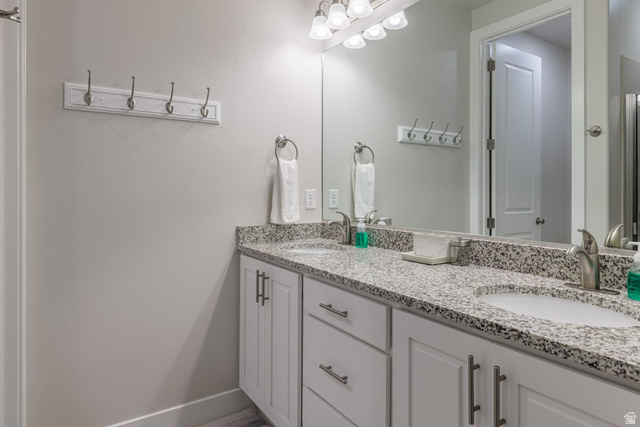 4845 Fishers Is Way St. George, UT 84770 - Photo 7 of 41 Full bathroom featuring double vanity and baseboards