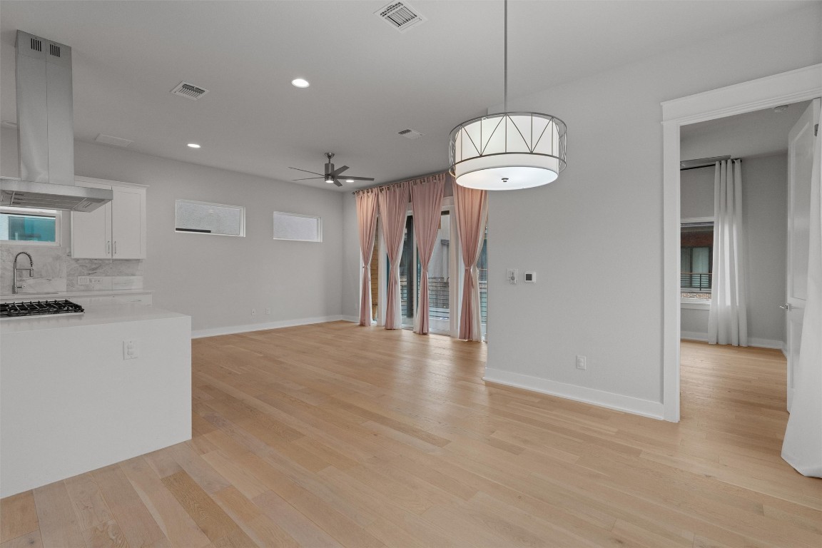 5002 Pecan Springs Road, Unit 1 Austin, TX 78723 - Photo 11 of 38 Unfurnished dining area featuring ceiling fan, light wood-type flooring, and recessed lighting