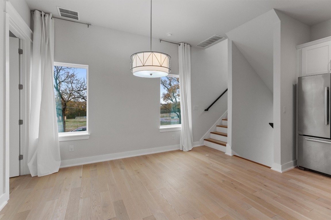 5002 Pecan Springs Road, Unit 1 Austin, TX 78723 - Photo 12 of 38 Unfurnished dining area featuring light wood finished floors and stairway