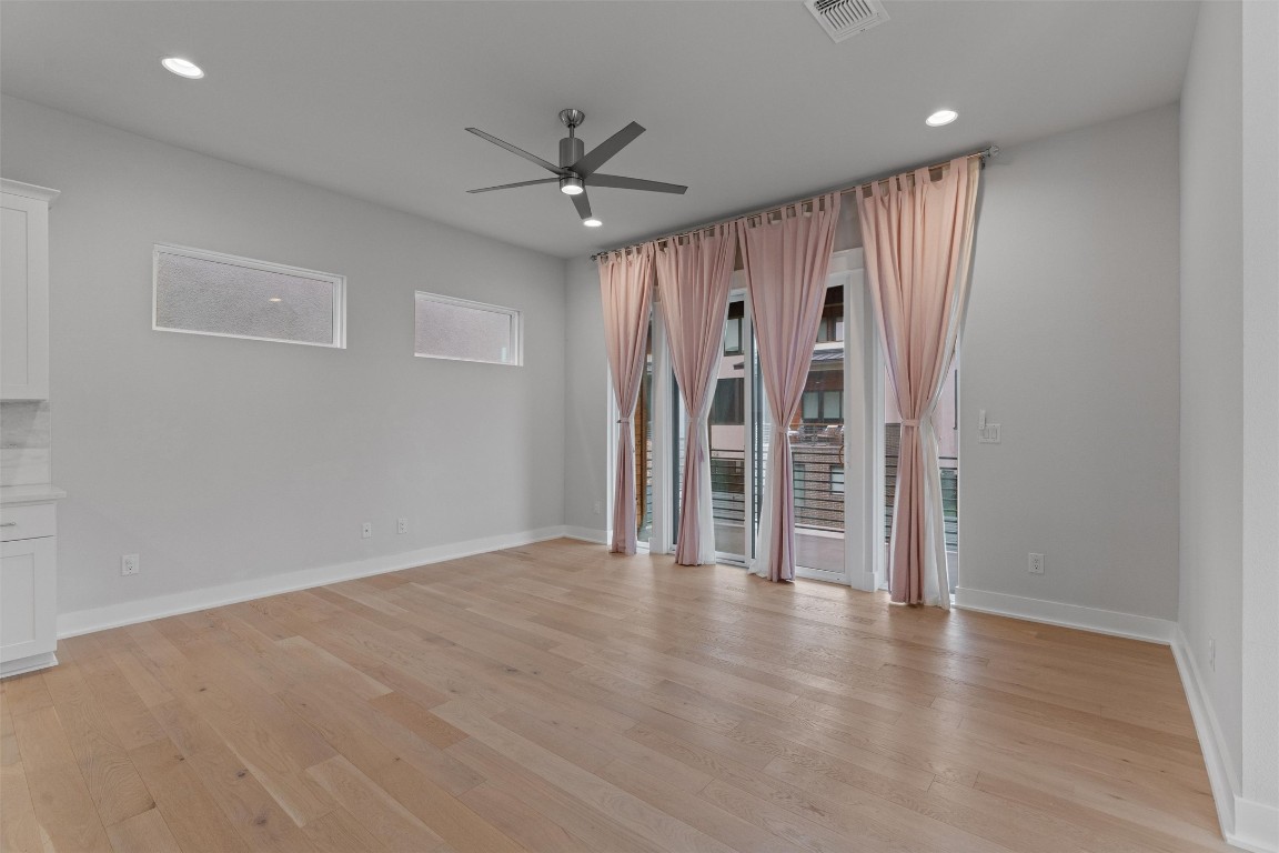 5002 Pecan Springs Road, Unit 1 Austin, TX 78723 - Photo 17 of 38 Unfurnished living room featuring ceiling fan, light wood-style flooring, and recessed lighting